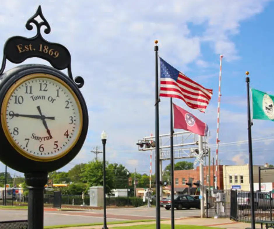 Smyrna Tennesse with a picture of a large clock tower and two flags