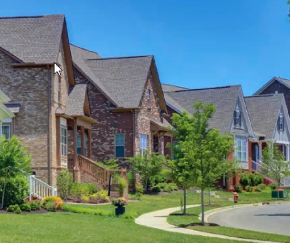 Newly constructed homes in Bellevue neighborhood, showcasing modern architecture and landscaped yards, with a clear blue sky in the background.