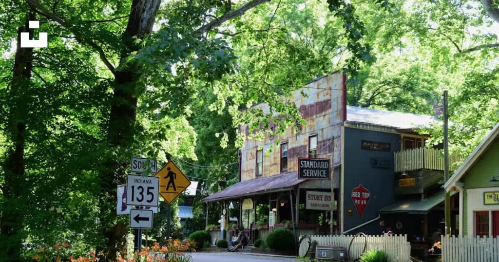 Historic buildings in Fairview, Tennessee, surrounded by lush greenery, featuring signs for Standard Service and Story Inn, with a pedestrian crossing sign on Indiana Highway 135.