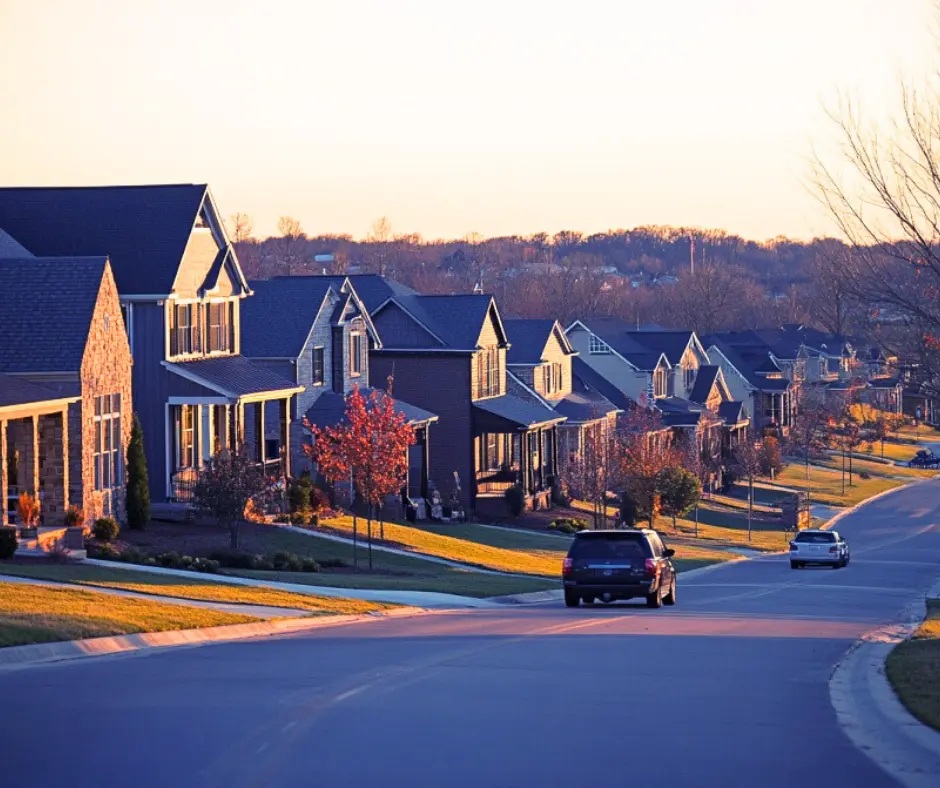 Residential neighborhood in Mt. Juliet, TN, featuring well-maintained homes, tree-lined streets, and vehicles on a quiet road, highlighting the area's charm and community appeal.