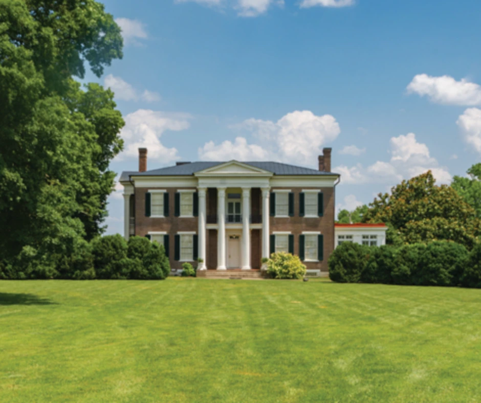 Historic home with columns and green lawn, representing the charm of Williamson County neighborhoods like Spring Hill.