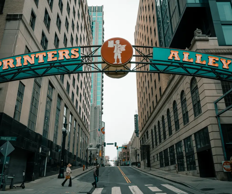 Printers Alley entrance sign in Nashville, showcasing historic architecture and vibrant urban atmosphere, reflecting The Nations neighborhood's growing community and cultural identity.